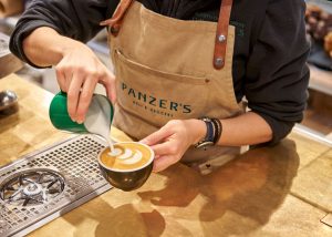 Barista pouring a latte