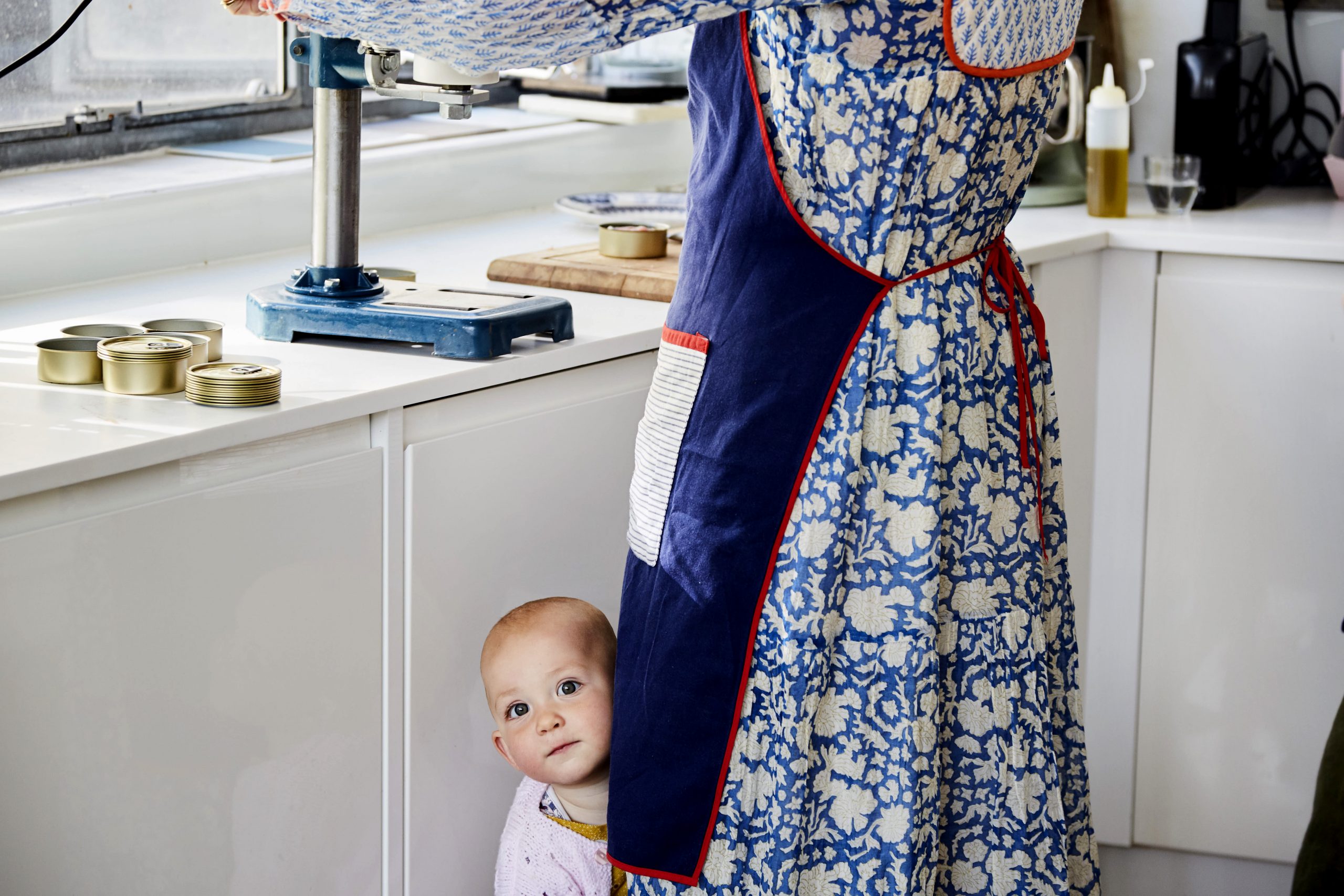 Daughter of Sea Sisters founders peeks out from behind an apron
