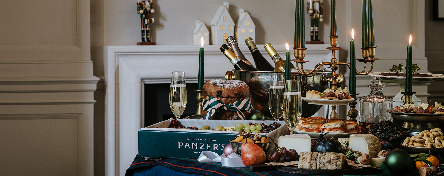 A cocktail table filled with Christmas food, catering platters and holiday treats