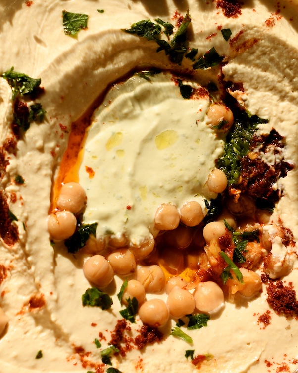 Ayelet's kosher hummus shot up close in detail showing the chickpeas, tahini and her dressing