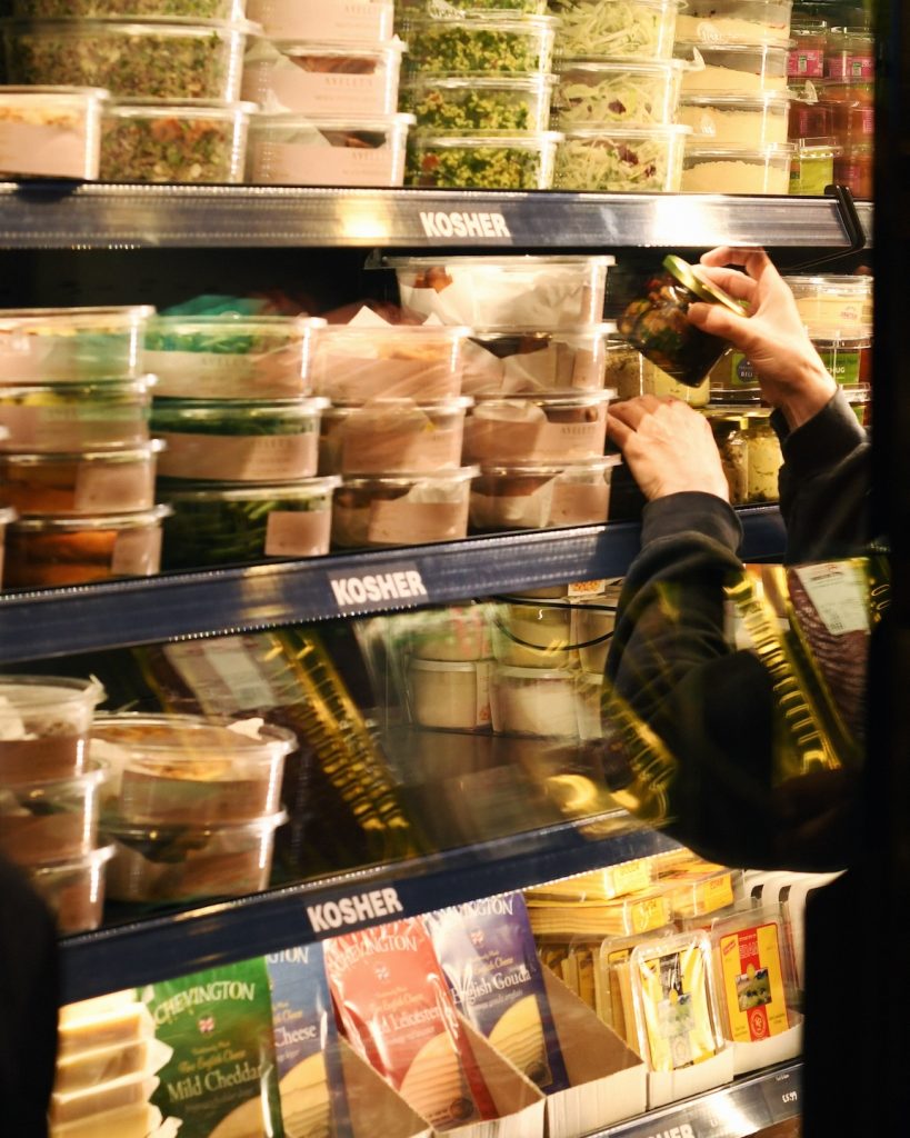 A fridge full of kosher products, like hummus & spreads at Panzer's