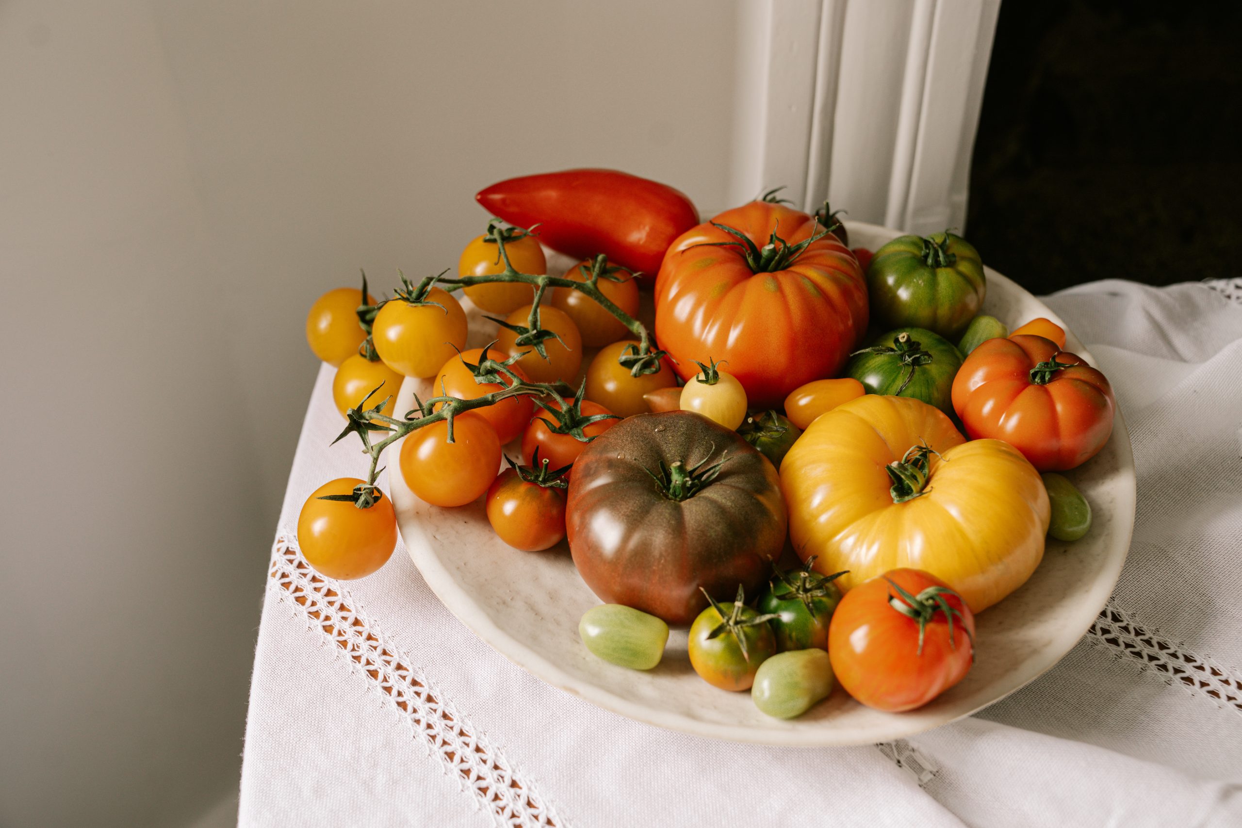 Selection of heritage tomatoes on a white tablecloth