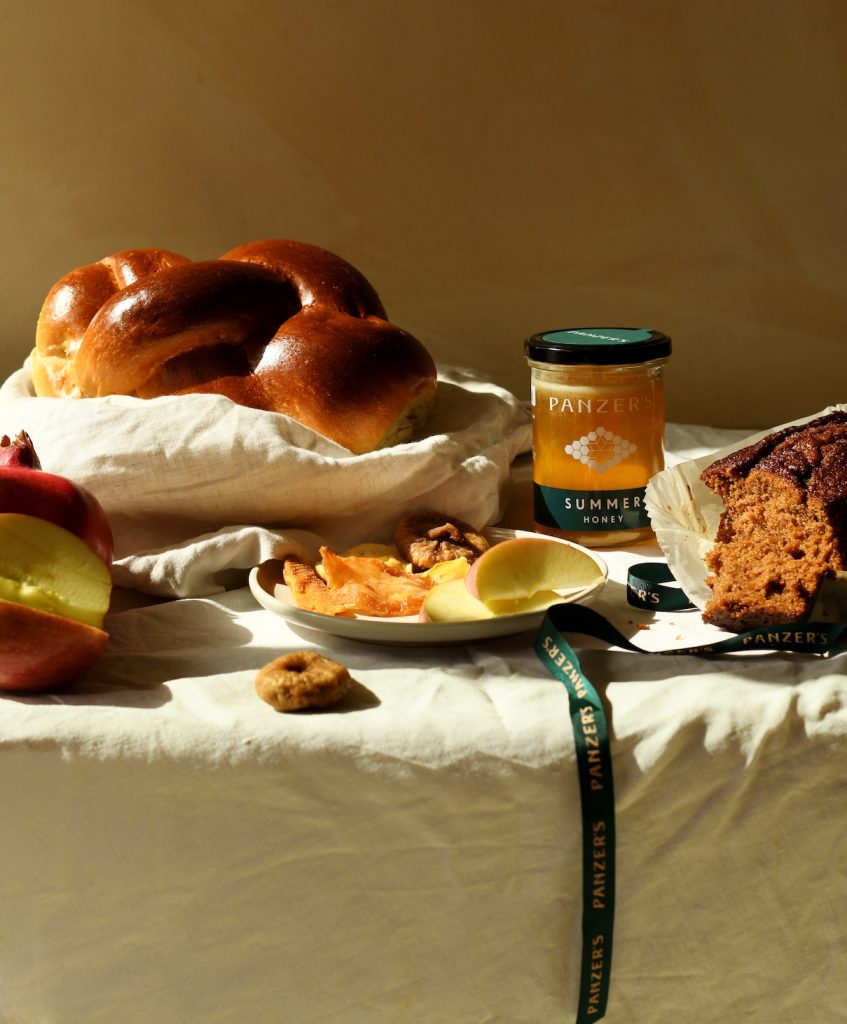 Panzer's Rosh Hashanah spread of challah, honey, smoked salmon, draped in a Panzer's ribbon