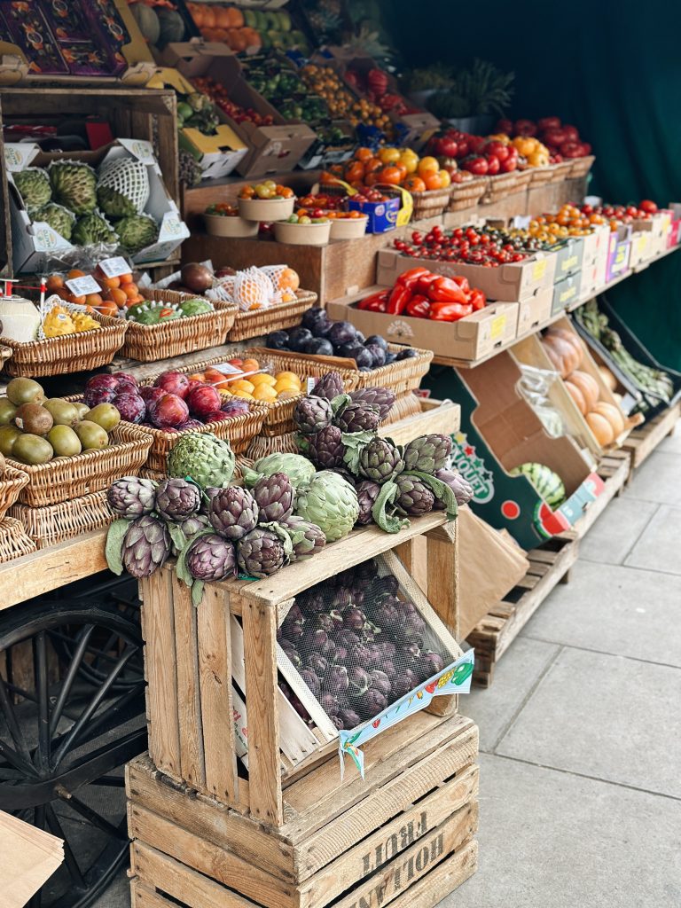 Fruit & Vegetable display outside the front of panzer's, with produce piled high