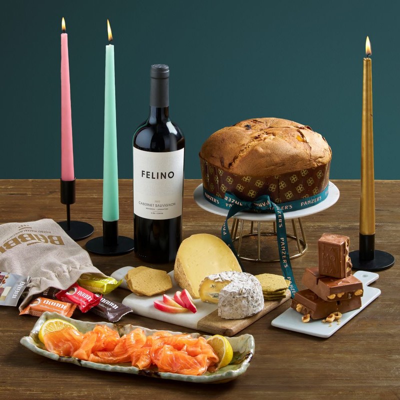 Christmas Connoisseur hamper styled in a festive lifestyle scene, showcasing luxury wines, fine foods, and gourmet seasonal treats.