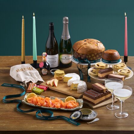 Splendid Christmas hamper displayed in a festive lifestyle setting, filled with luxury food, wine, and seasonal treats.