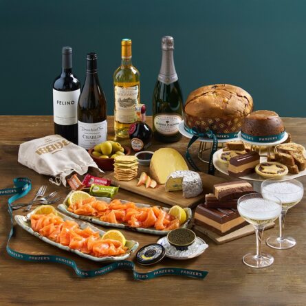 Lifestyle photo of the “Going Overboard” Christmas hamper, overflowing with festive treats, fine wines, and gourmet delicacies, beautifully presented for the holiday season.