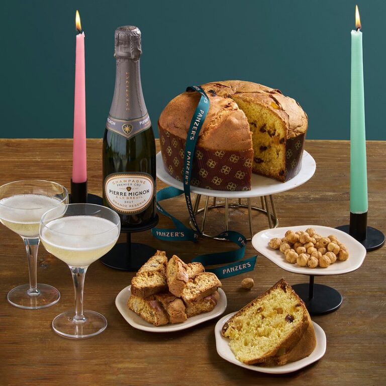 Buone Feste Christmas hamper styled in a festive lifestyle setting, overflowing with Italian-inspired gourmet treats, wine, and seasonal delights.
